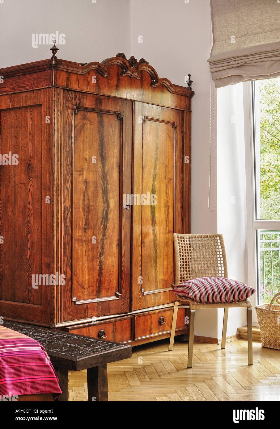 Carved Timor Sitting Bench Next To Vintage Wardrobe In Bedroom Uk & Irish  Use Only Stock Photo – Alamy With Old Fashioned Wardrobes (View 16 of 20)