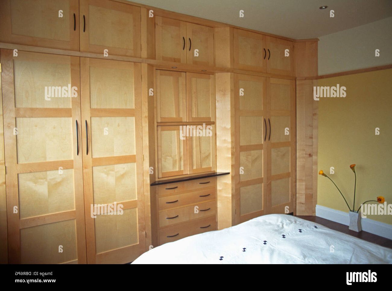 Pale Wood Fitted Wardrobes And Storage Units Along The Length Of One Wall  In Modern Bedroom Stock Photo – Alamy Within Bedroom Wardrobes Storages (View 17 of 20)
