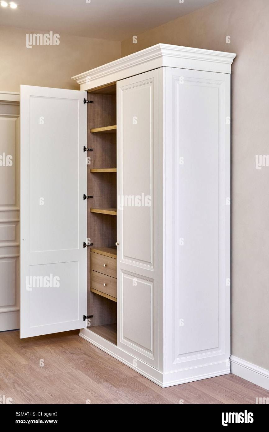 White Vintage Wardrobe With Crown Moldings Wooden Shelves And Drawers And  Open Facade Door In Light Empty Room In Luxury Apartment Stock Photo – Alamy With Regard To White Vintage Wardrobes (View 8 of 20)